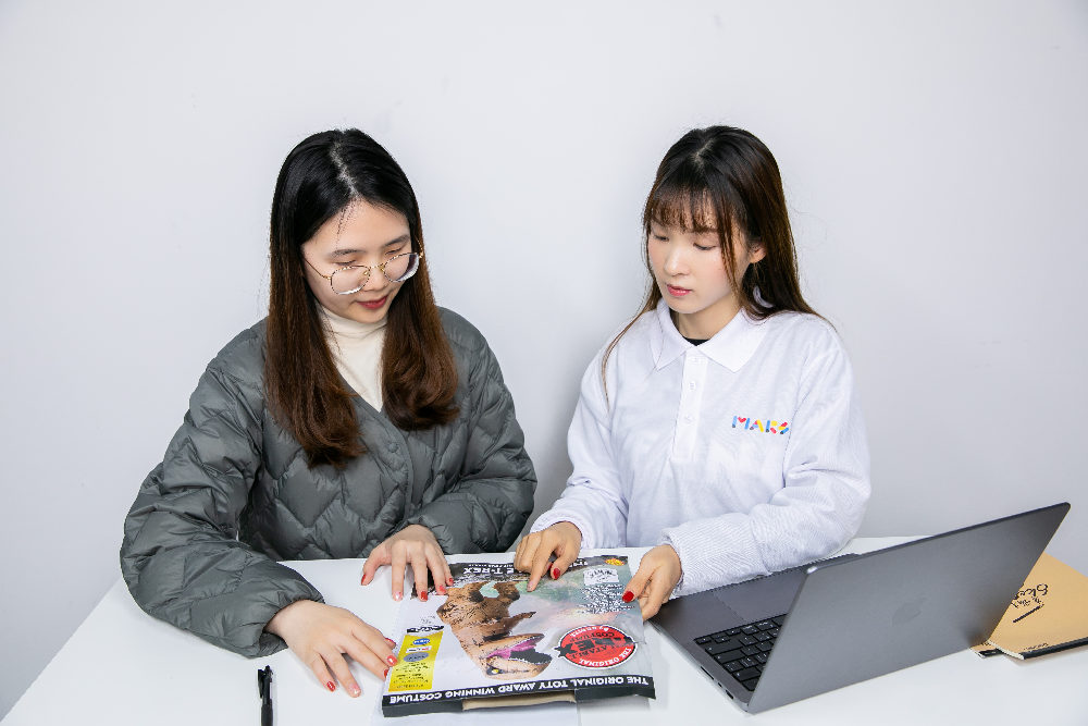 A staff member holding a product drawing to recommend inflatable products to a customer.