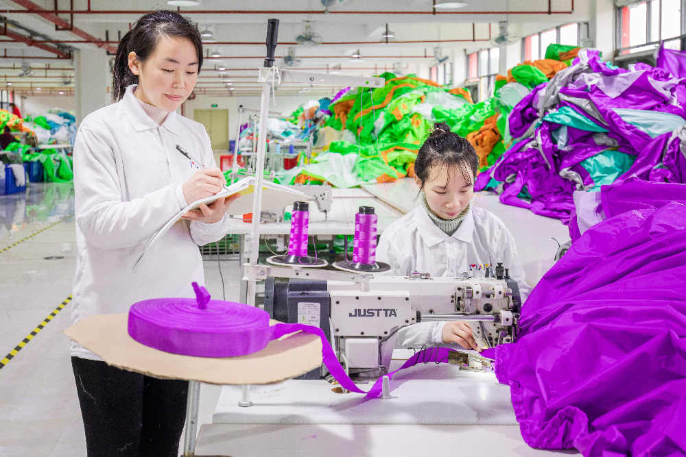 A worker inspecting semi-finished products on the assembly line.